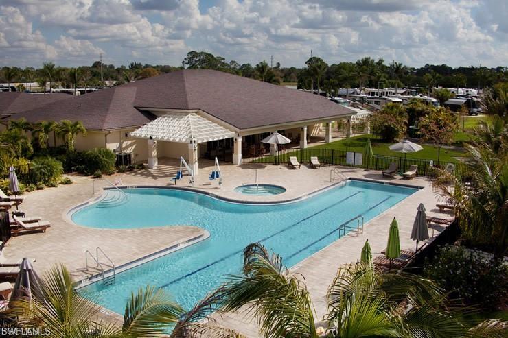 Community pool featuring a patio area and a hot tub