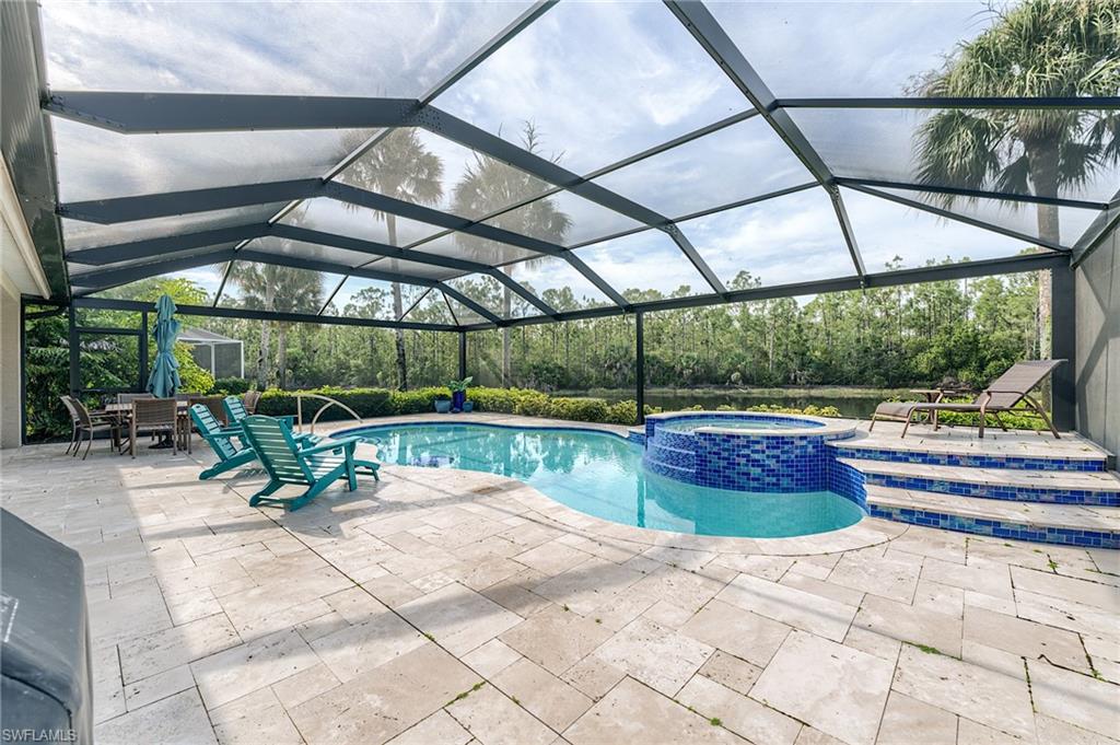 TRAVERTINE PAVERS AND NEWER SCREENED ENCLOSURE FOR OPTIMAL VIEW