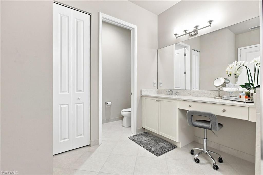 Recessed vanity with stone countertop, integrated sink, and undermount cabinetry