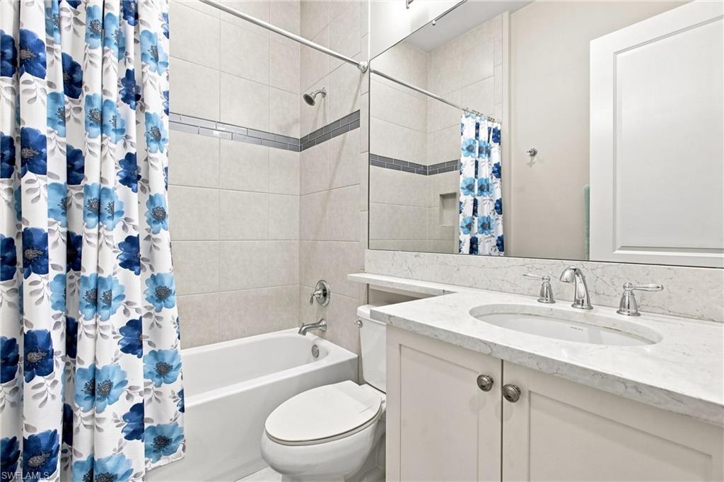 Full vanity mirror over a single-basin sink with chrome hardware