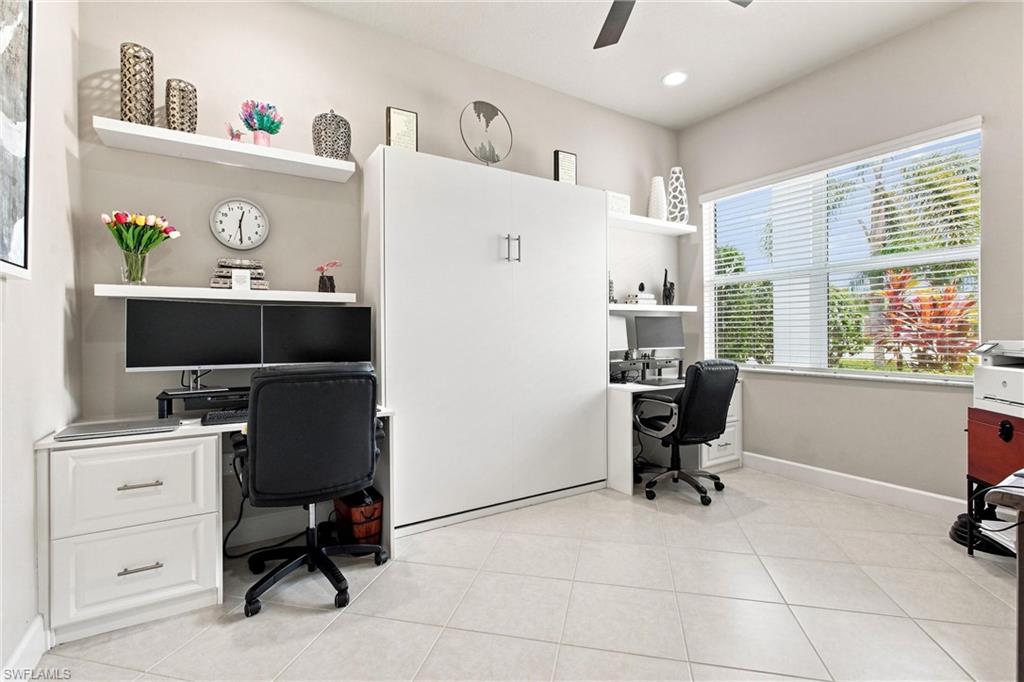 Recessed lighting, ceiling fan, expansive window with blinds, tile flooring, and integrated wall unit