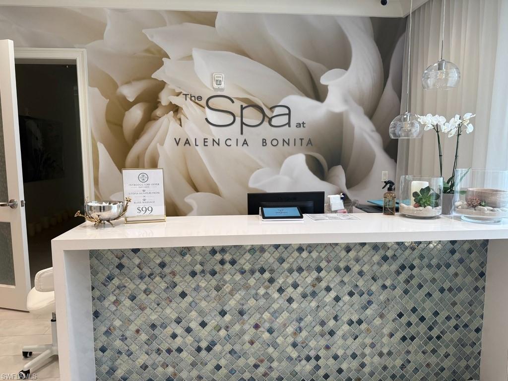 Reception desk with a white countertop and mosaic tile facing