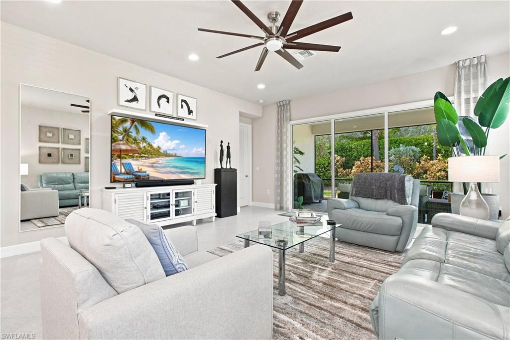 Recessed lighting, wood-finish ceiling fan, and large format tile flooring