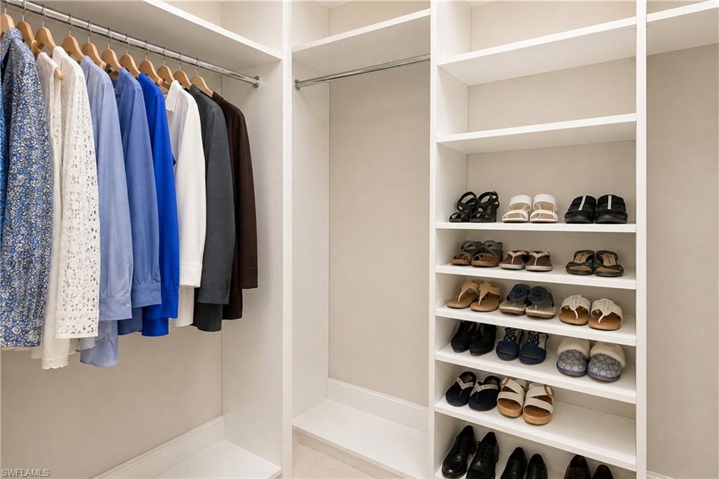 Built-in closet system featuring multiple hanging rods and integrated shelving