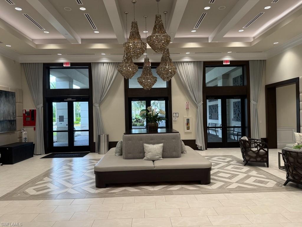 Recessed lighting, layered tray ceiling, light-colored tile flooring, multiple chandeliers, and full-height windows