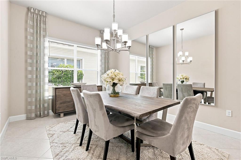 Recessed lighting, contemporary chandelier, large windows with blinds, built-in sideboard, and large wall-mounted mirrors