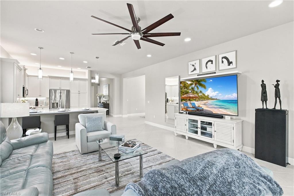 Open-concept living area with tile flooring and a ceiling fan