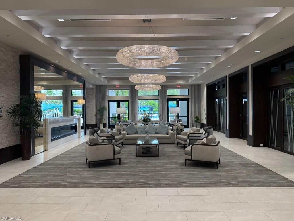 Spacious common area featuring recessed lighting, large windows, a built-in fireplace, and tile flooring