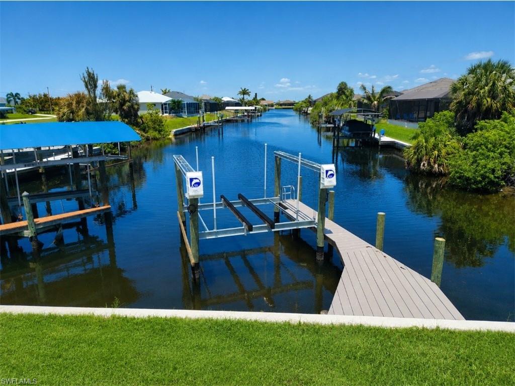 Private dock and boat lift overlooking the canal and surrounding waterfront homes