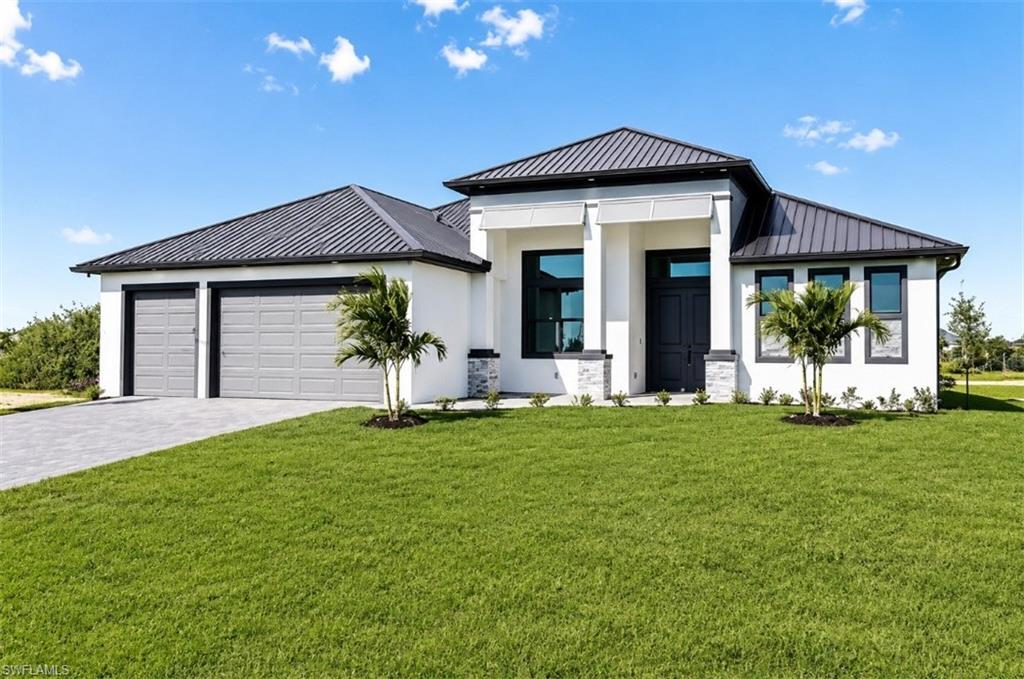 Contemporary front elevation featuring clean architectural lines, a three-car garage, and attractive landscaping.