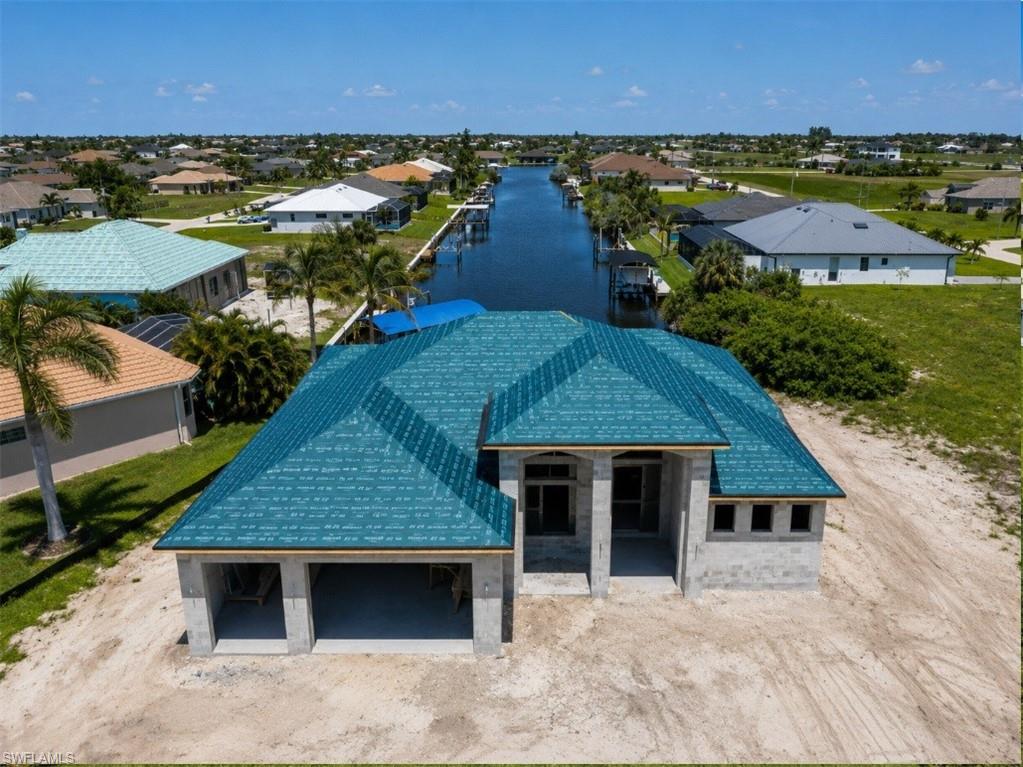Aerial view of the waterfront property, canal frontage, and surrounding neighborhood.