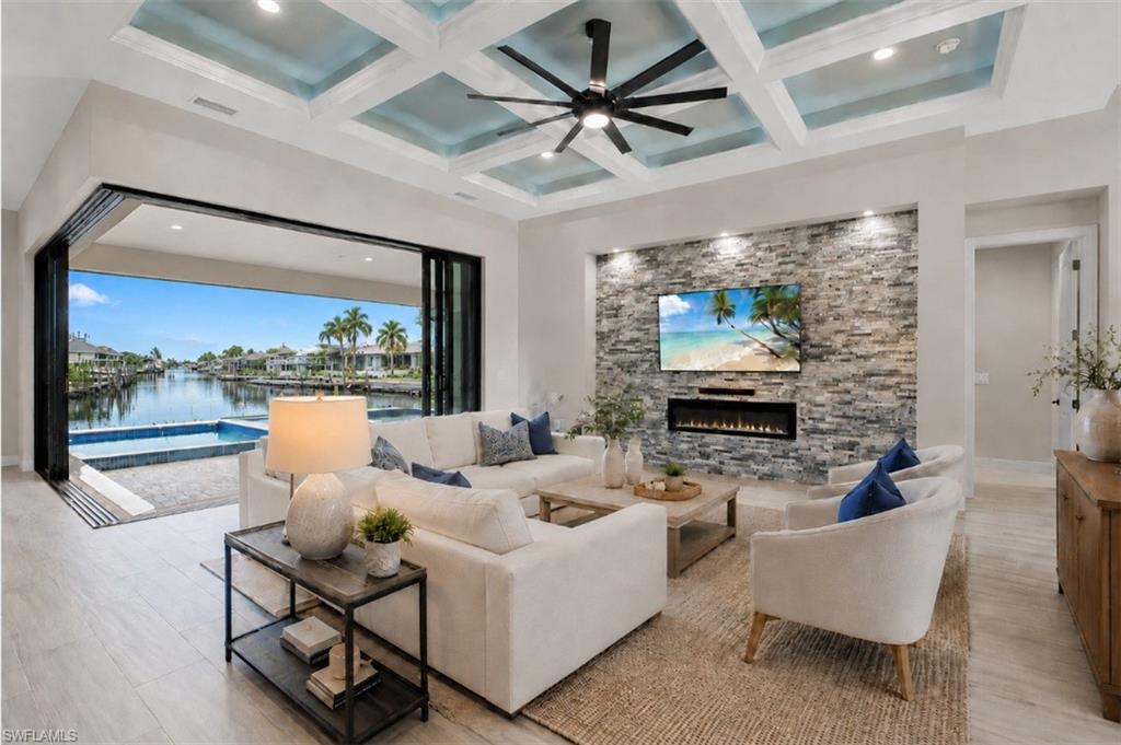 Open-concept living area with modern finishes, detailed ceiling design, and expansive outdoor views. AI-generated and virtually staged.