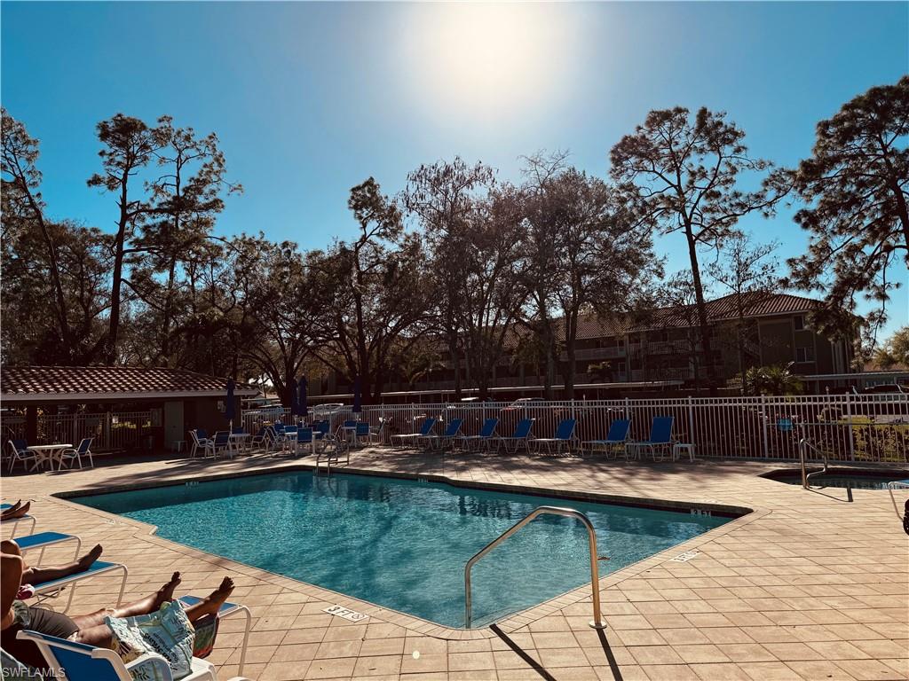 Outdoor swimming pool with integrated spa and surrounding paver deck