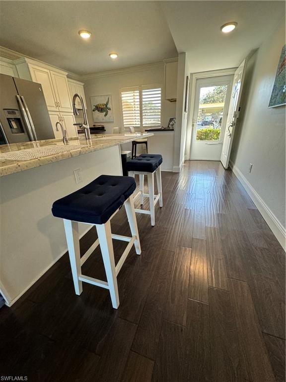 Dark wood-finish flooring extending from the entryway