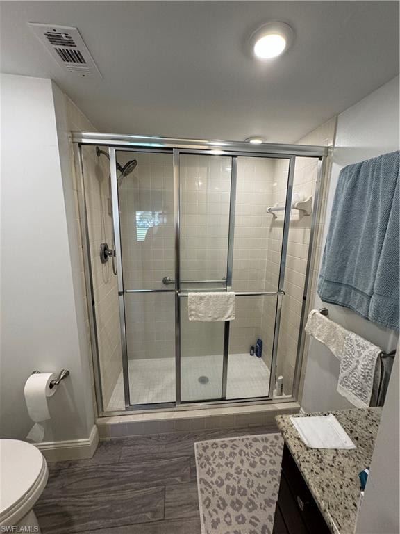 Walk-in shower with clear glass enclosure and tile surround