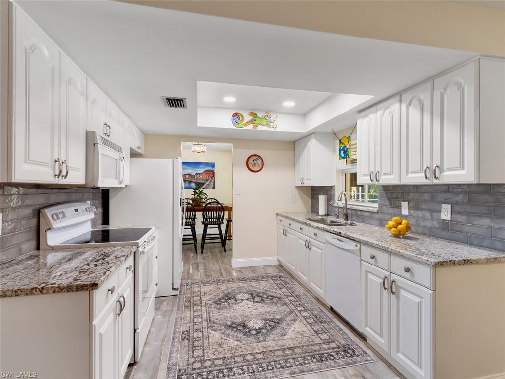 Updated lighting, countertops, & backsplash; newer appliances