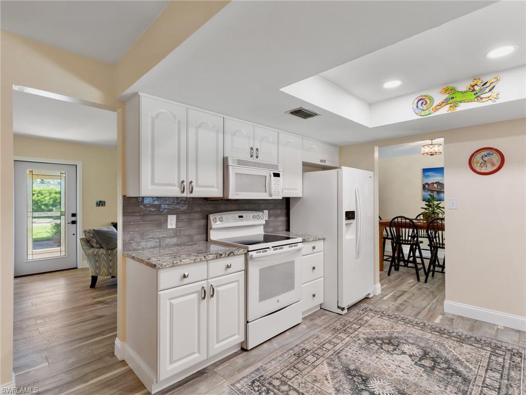 Kitchen toward entry and living room, dining area