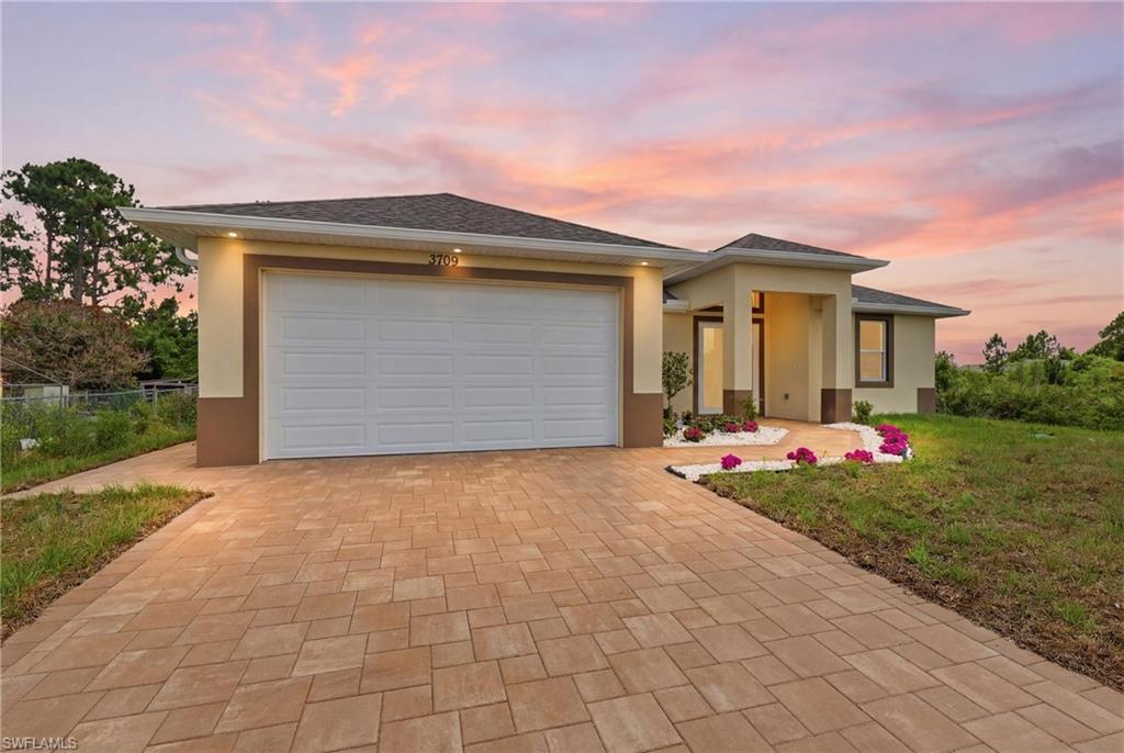 Stucco exterior with a paver driveway