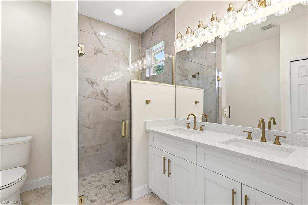 Dual vanity with white cabinetry and light-toned countertops