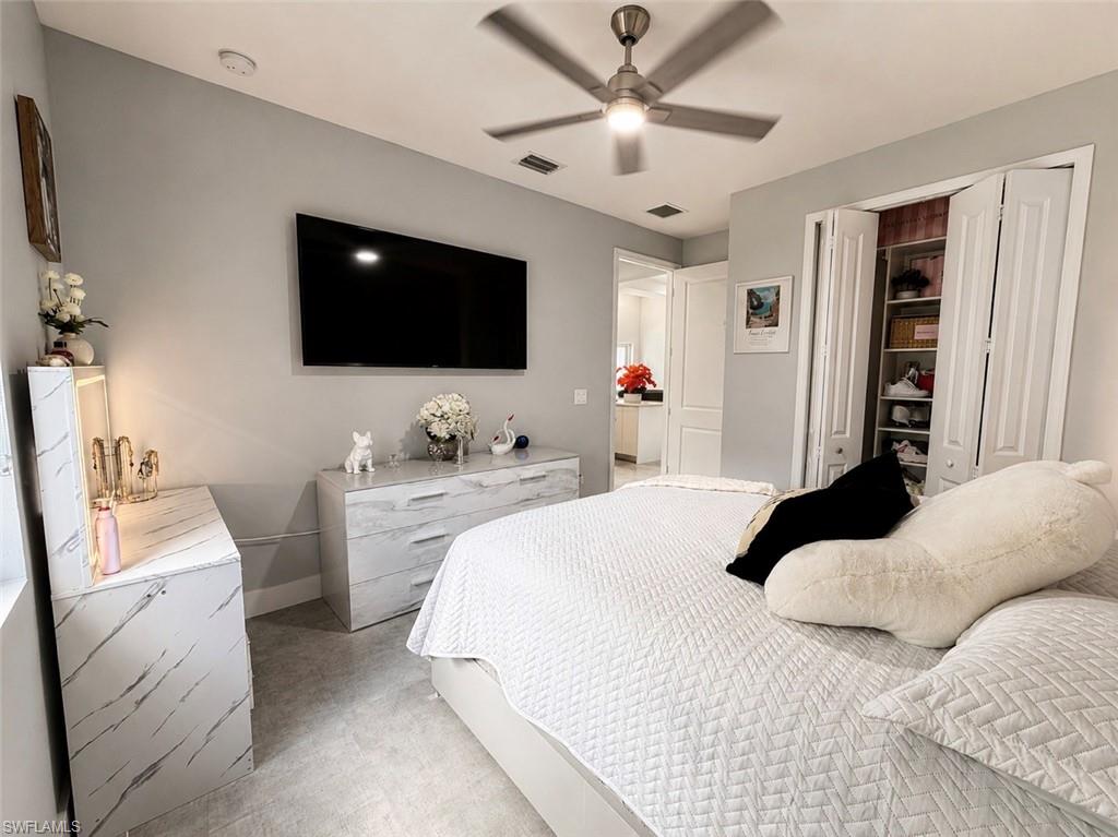 Recessed lighting, ceiling fan, bi-fold closet doors, and tile flooring