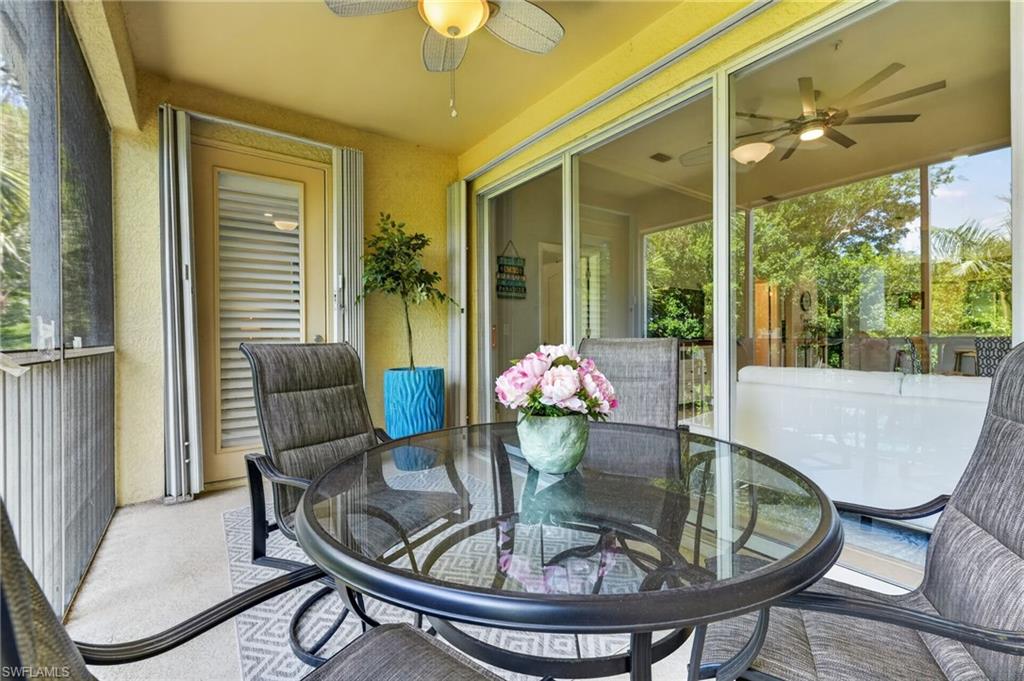 Screened balcony featuring a ceiling fan, sliding glass doors.