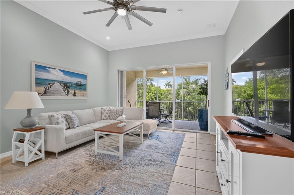 Ceiling fan with integrated lighting, recessed lighting, crown molding, sliding glass doors, and tiled flooring.