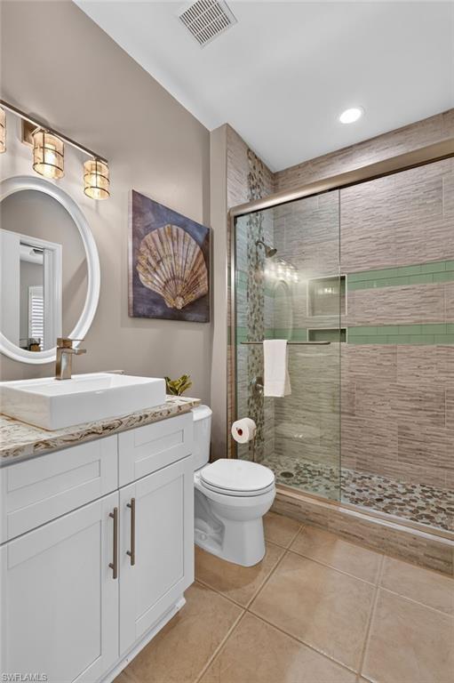 White shaker vanity with a surface-mounted rectangular basin.