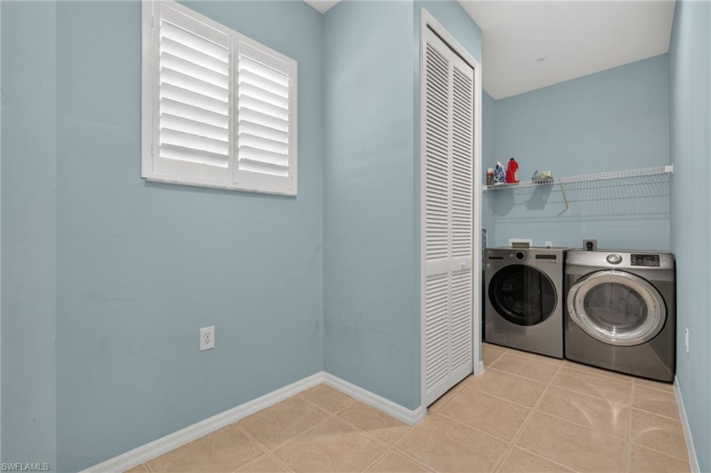 tiled flooring, louvered bi-fold doors, and wire shelving
