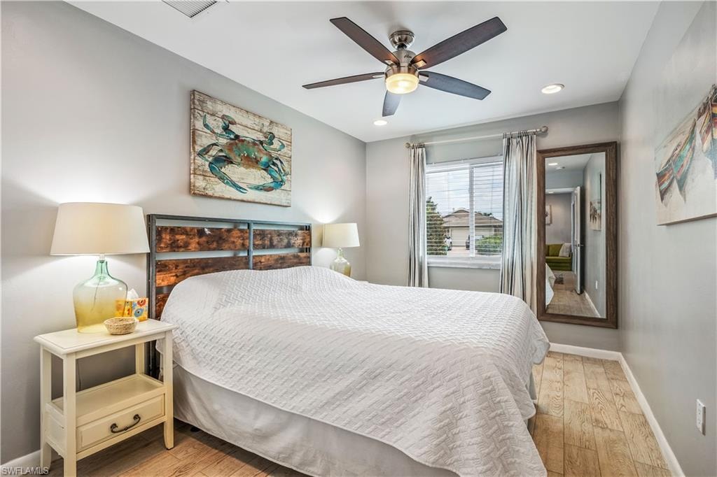 Bedroom with ceiling fan and light hardwood / wood-style flooring