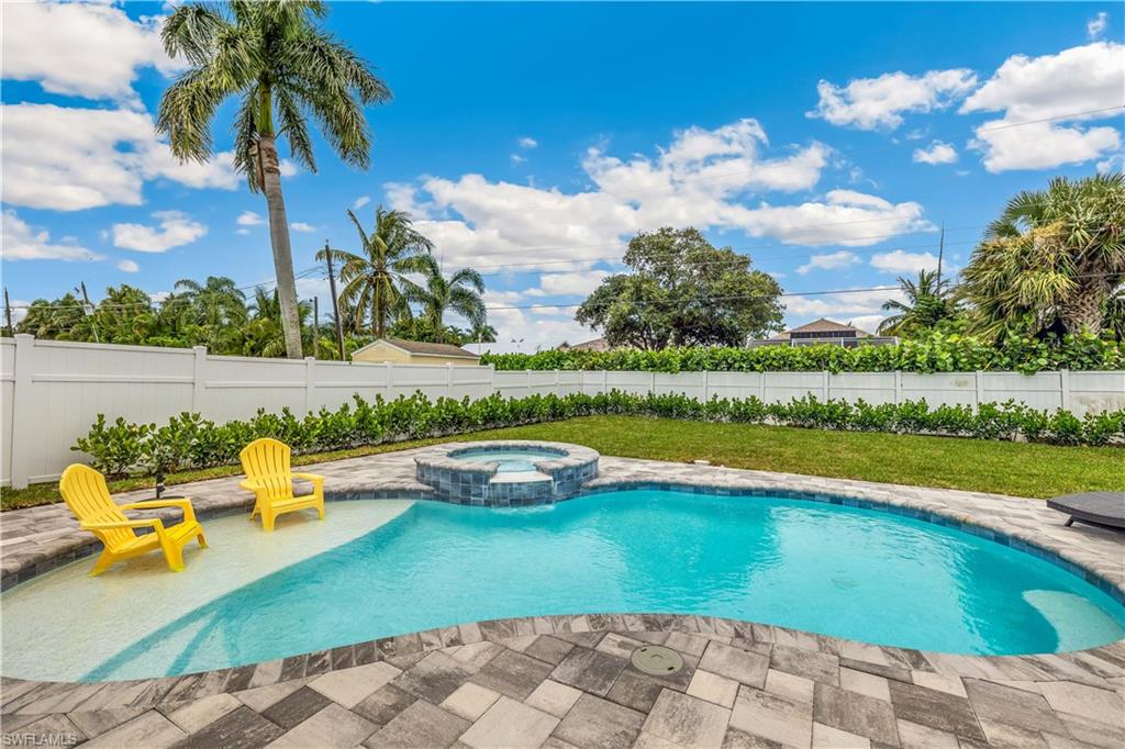 View of swimming pool featuring an in ground hot tub and a patio area