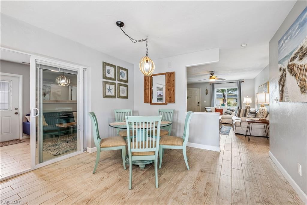Dining room with light wood-type flooring and ceiling fan