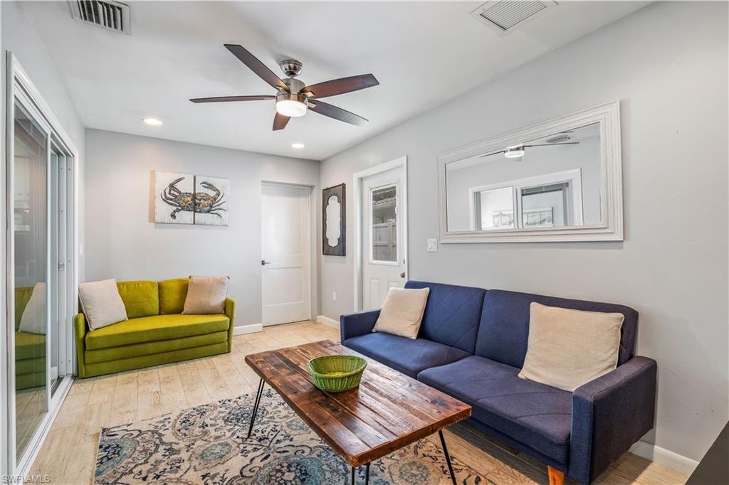 Living room featuring ceiling fan and light hardwood / wood-style flooring