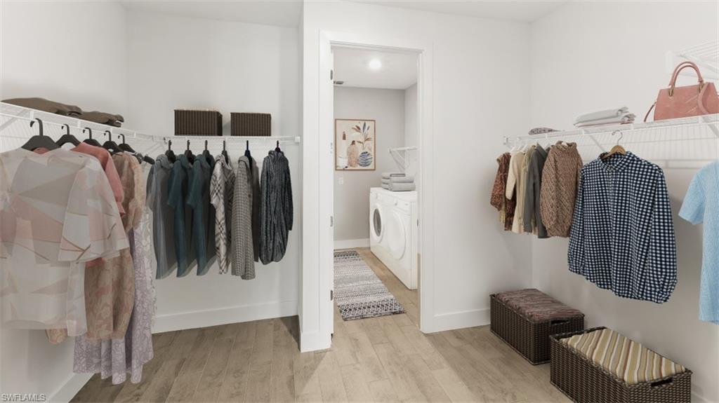 Walk-in closet featuring wire shelving, hanging rods, and wood-finish flooring