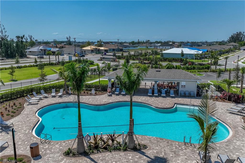 Community swimming pool with a shaped design and a surrounding paver patio