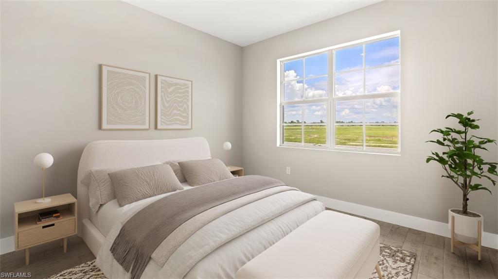 Expansive window, light wood-finish flooring, and crisp white trim