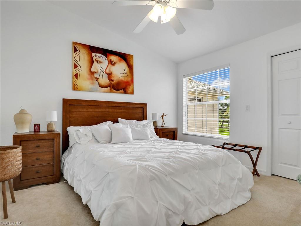 Recessed lighting, ceiling fan, window with blinds, wood-finish flooring, and a built-in closet with bifold doors
