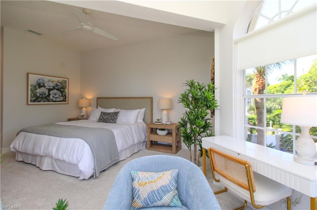 Carpeted bedroom with ceiling fan and visible vents