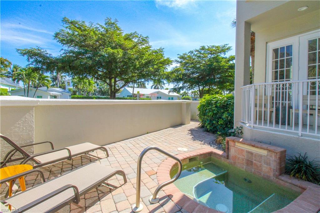 View of patio / terrace with an in ground hot tub