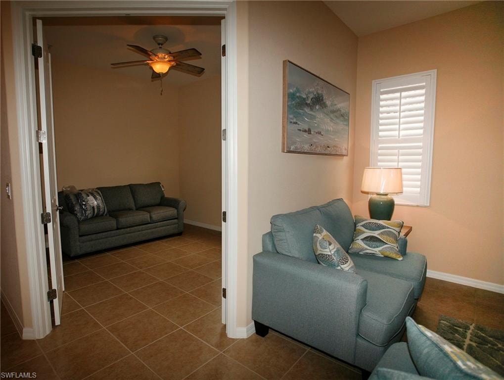 Neutral wall tones, plantation shutters, and ceiling fan