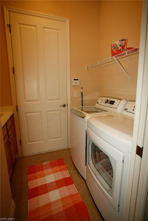 Laundry area with tile flooring, a white wire shelving unit, and a built-in wood-finish cabinet