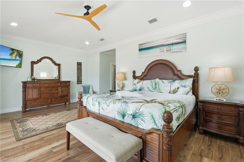 Wood-finish flooring, crown molding, recessed lighting, and a modern ceiling fan - Virtually Edited Image