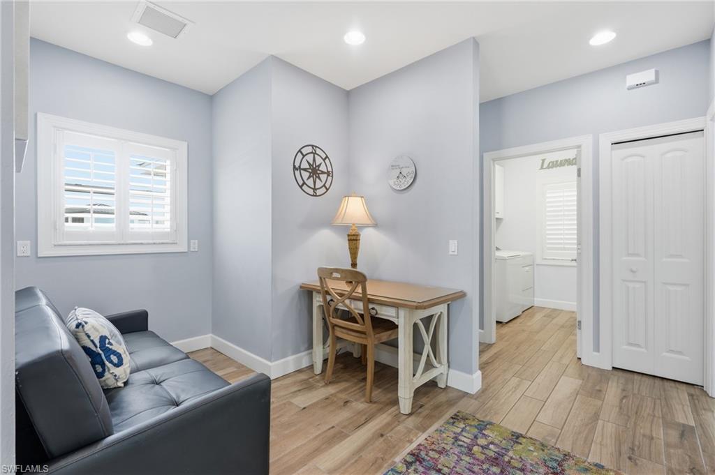 Recessed lighting, wood-finish flooring, plantation shutters, and white trim - Virtually Edited Image