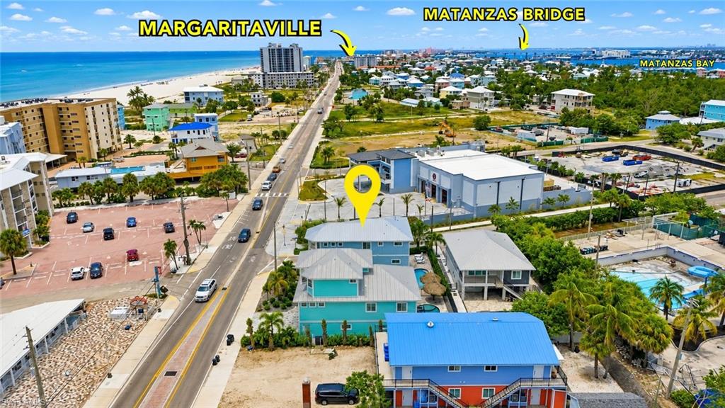 Coastal property with direct street frontage, featuring a two-story structure with a covered patio - Virtually Edited Image