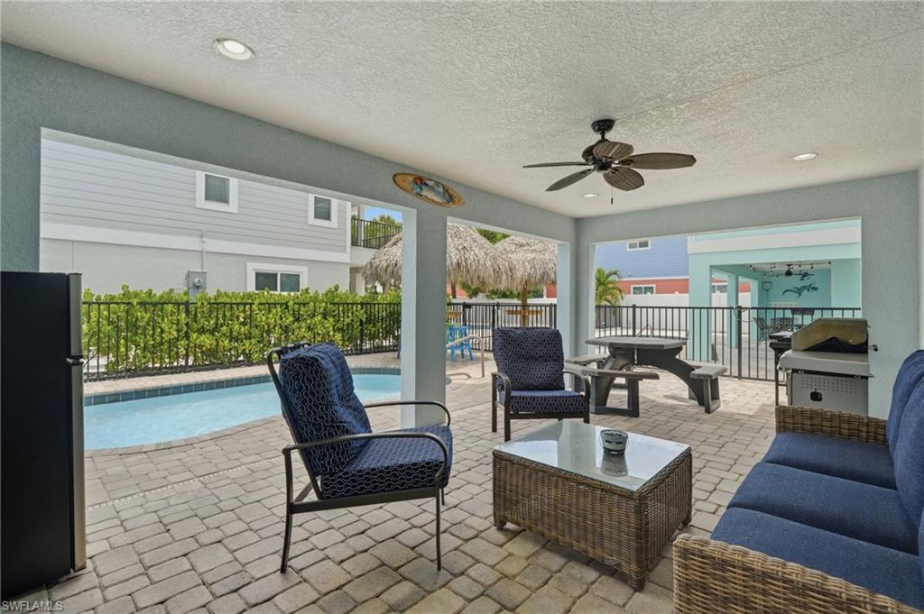 Covered patio featuring recessed lighting, a ceiling fan, and paver flooring - Virtually Edited Image