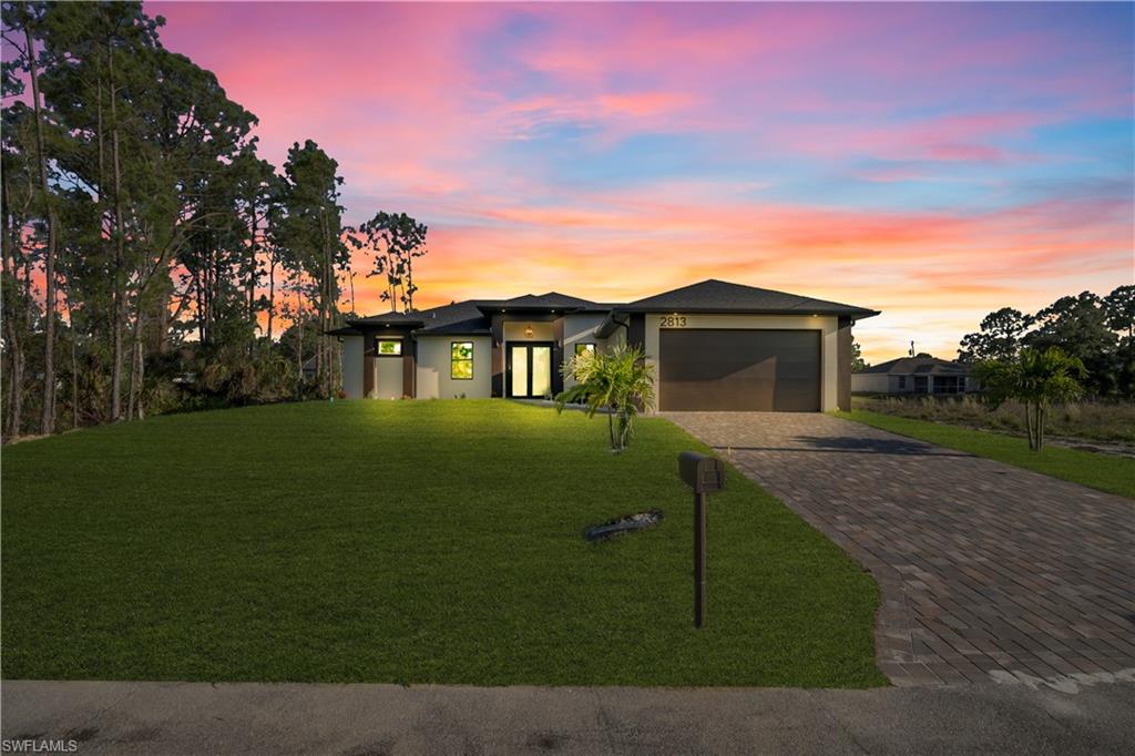 Contemporary exterior with clean lines, dark trim, and a prominent garage