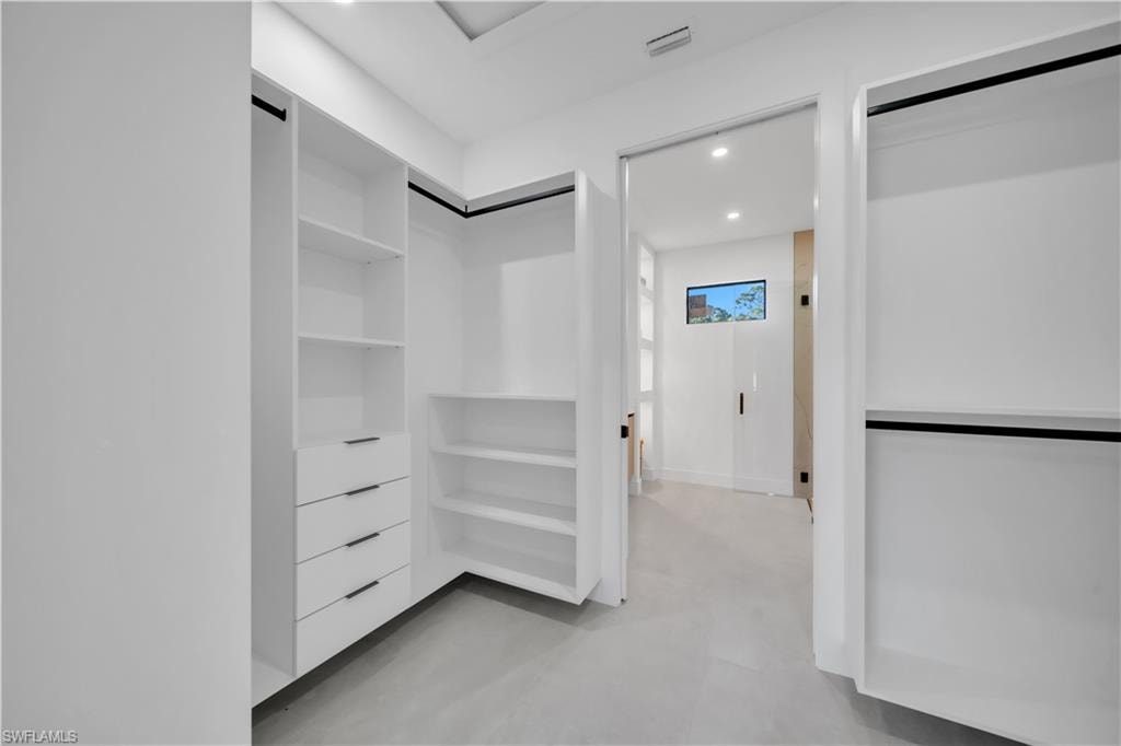 White built-in closet system featuring shelving and drawers