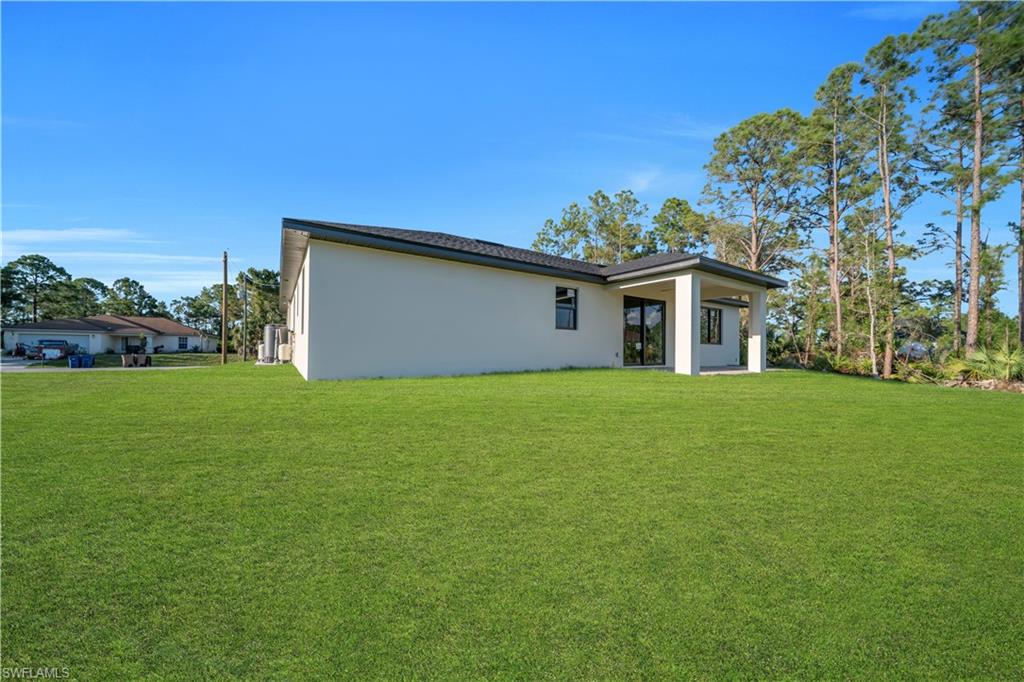 Expansive green lawn surrounds the property