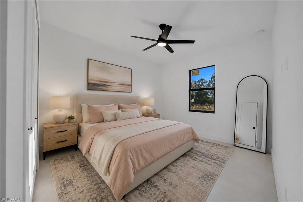 Spacious room with a ceiling fan, a window, and a door with black hardware