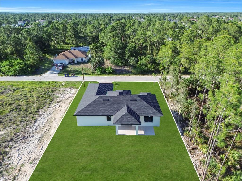 Newly constructed single-story residence with a dark shingle roof and light-colored exterior