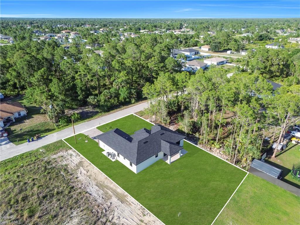 Newly constructed residence featuring a dark shingle roof and light-colored siding